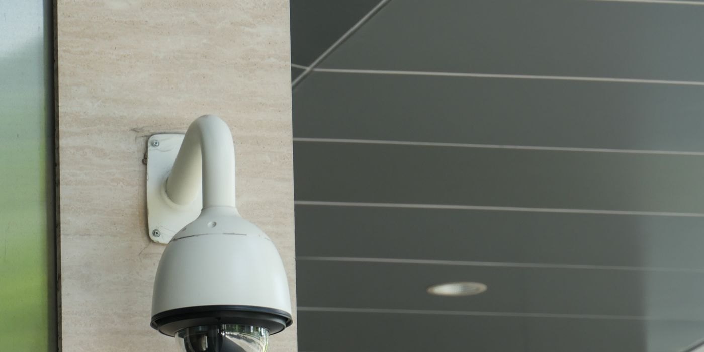 A dome security camera fitted to the outside of a building